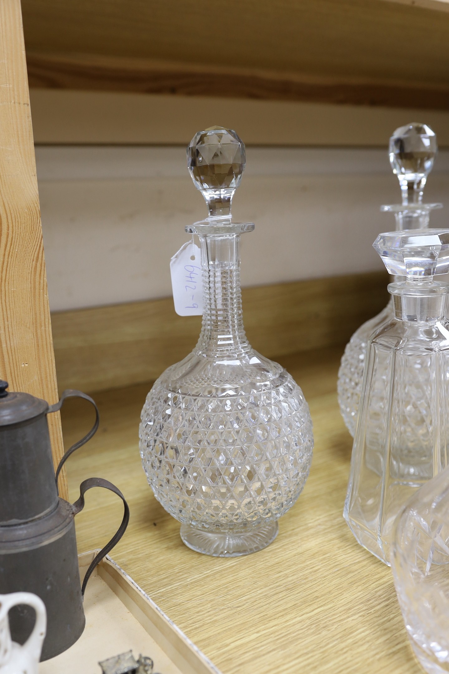 A pair of hobnail cut decanters two other pairs of cut glass decanters a single decanter and a glass and plate biscuit barrel